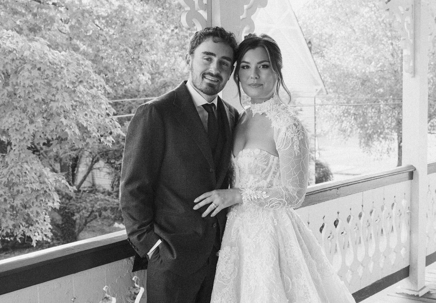 couple posing on bed and breakfast porch