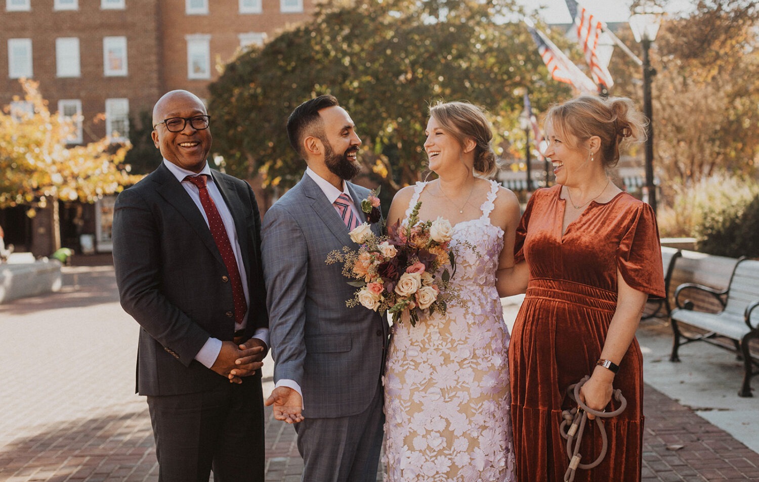 small wedding group photo with the couple and their guests