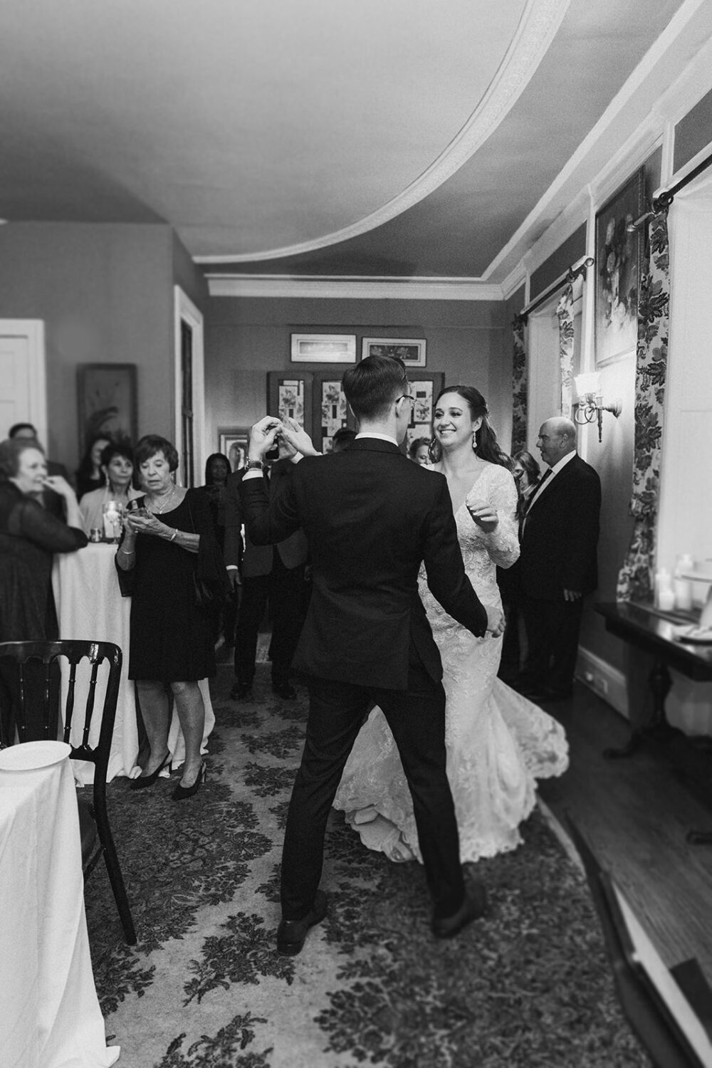 couple dancing at small wedding reception with their guests