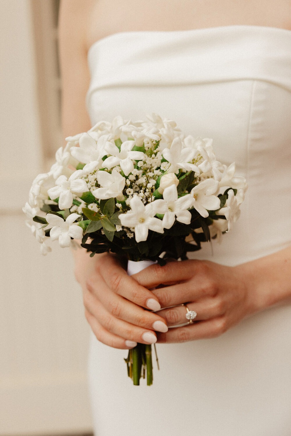 bride holding white wedding bouquet