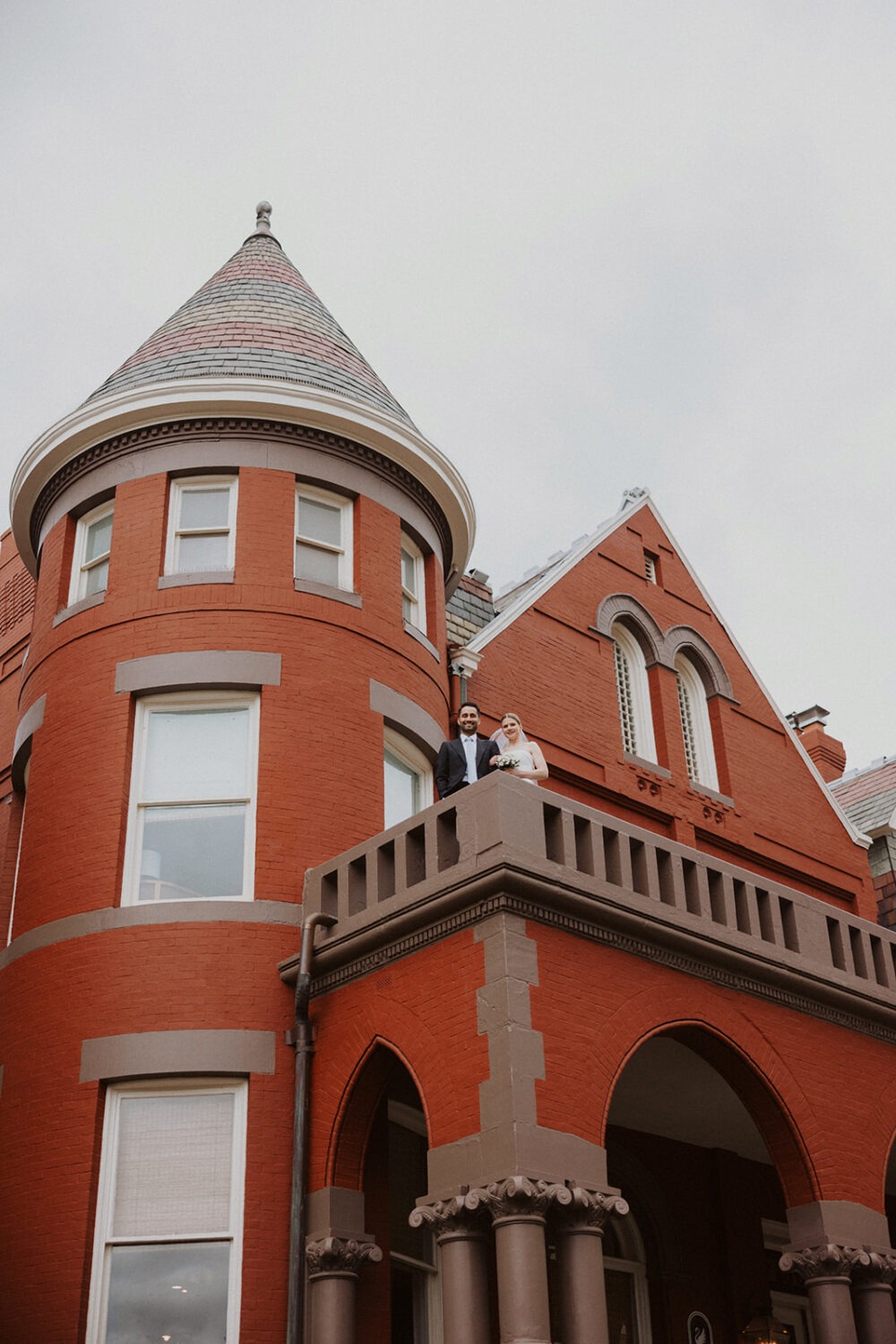 couple poses outside on upper terrace at historic Swann House DC