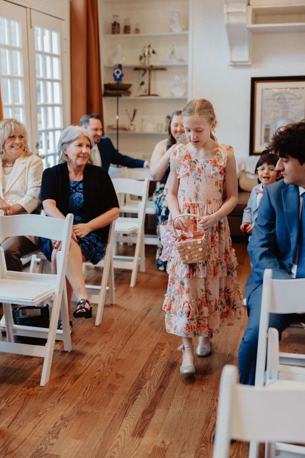 bride's niece walking down the aisle as flower girl