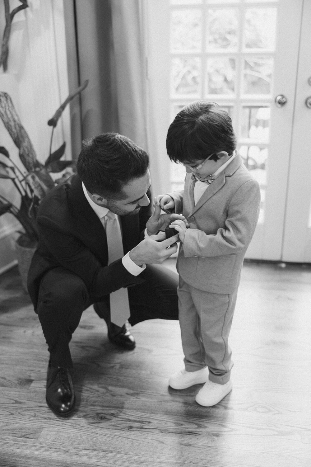 groom with ring bearer during wedding ceremony