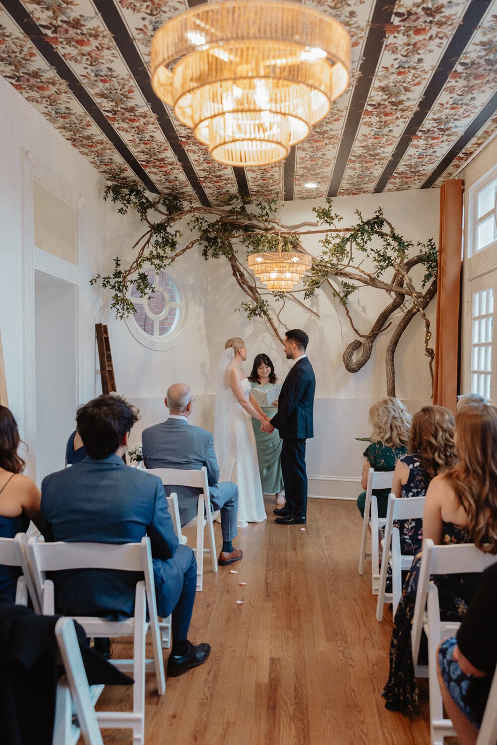 couple hold hands during wedding ceremony