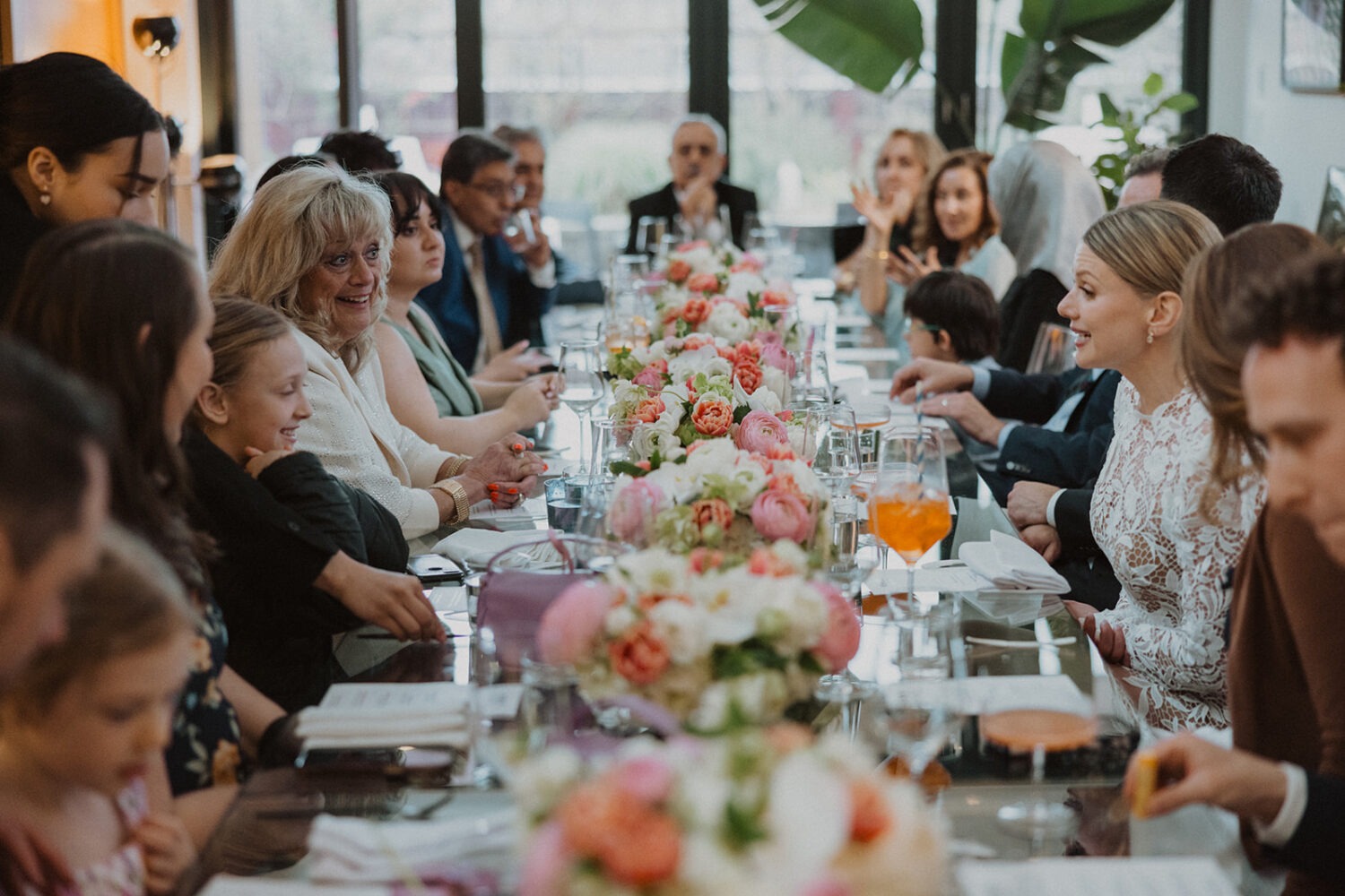 Guests seated around a long table during a small wedding reception