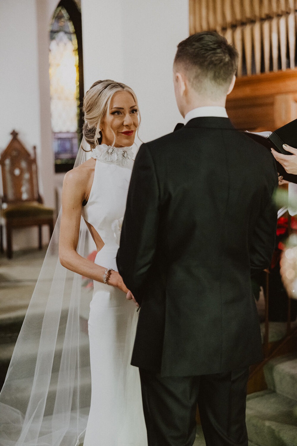 couple holding hands during wedding ceremony