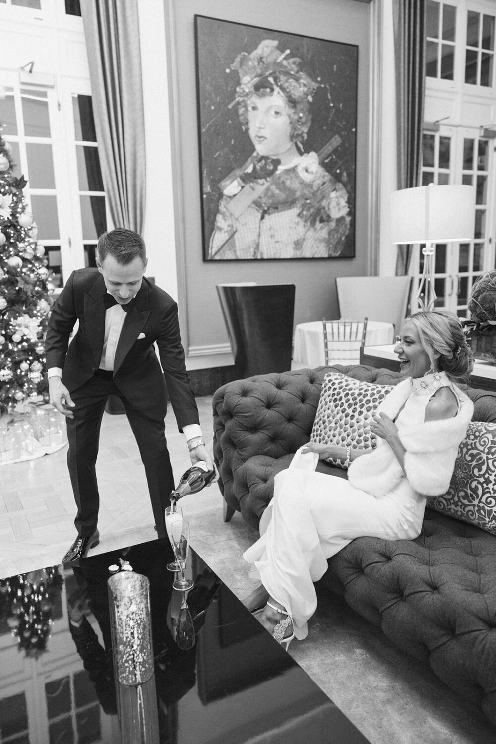 groom pouring bride a glass of champagne