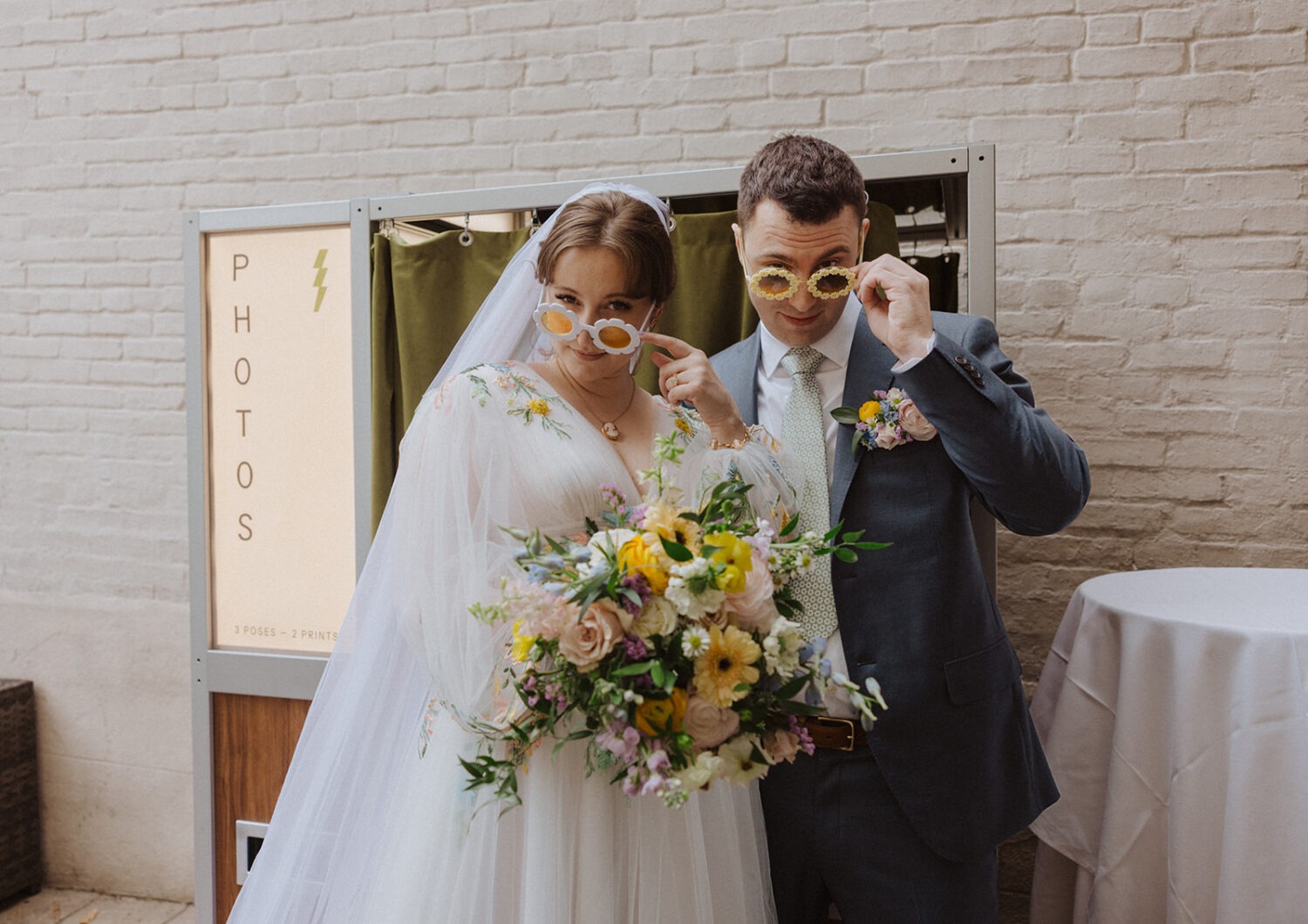 couple poses with their fun sunglasses
