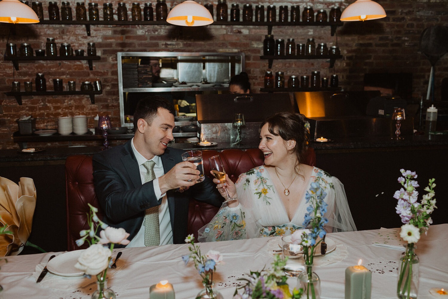 couple toast together during wedding reception 