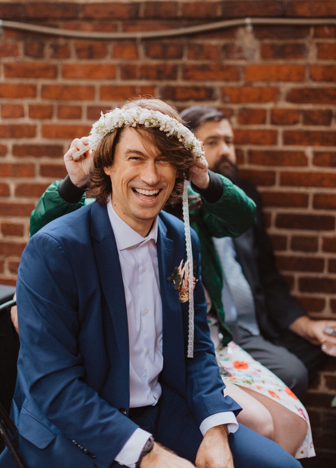 wedding guest putting on flower crown