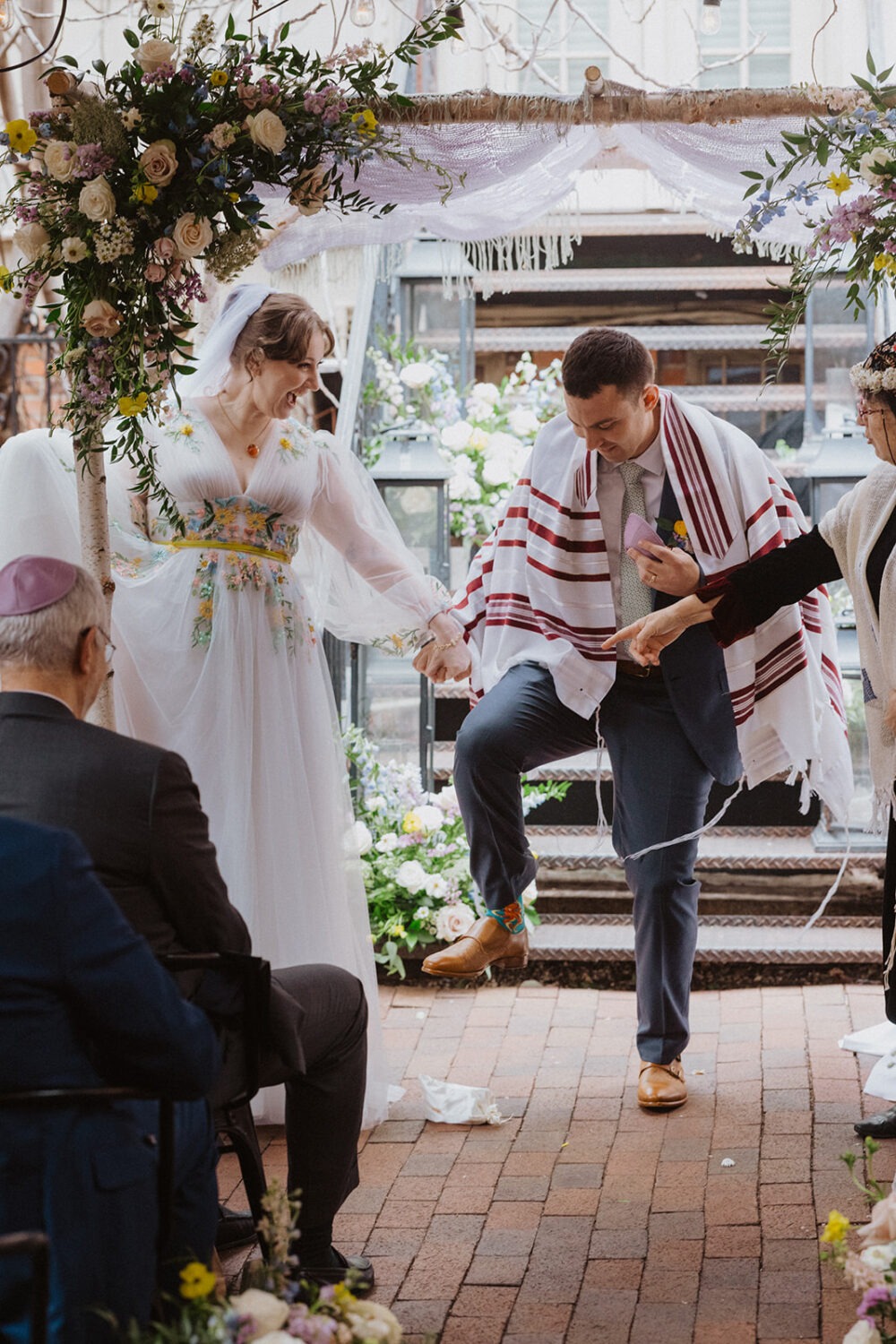 couple performing a Jewish tradition during small wedding ceremony