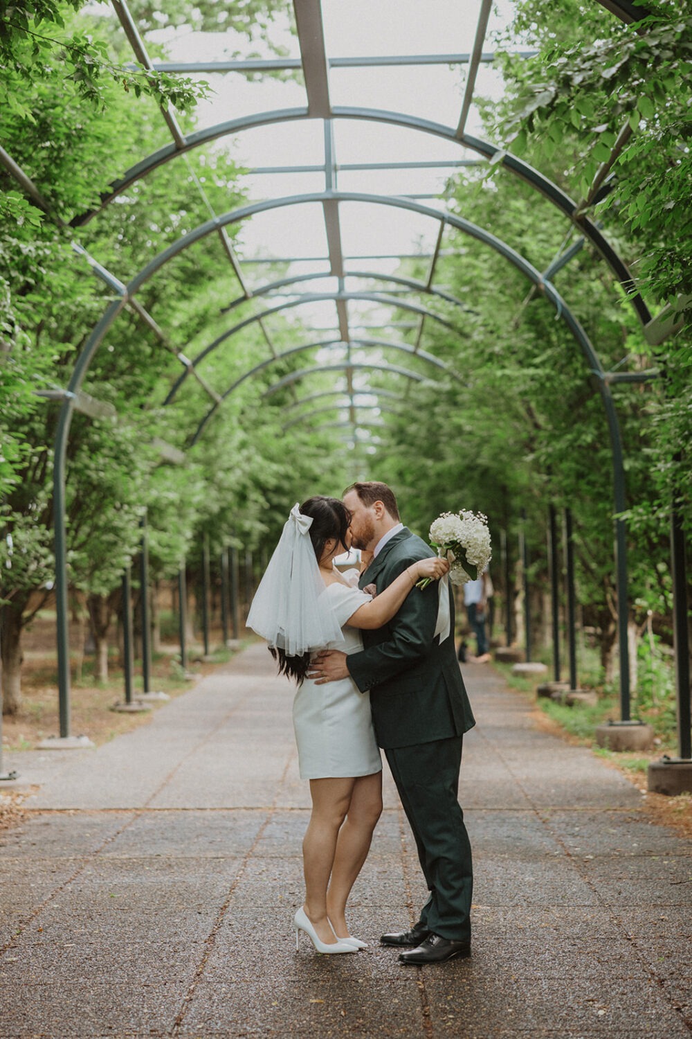 couple kisses under arches at Meridian Hill Park