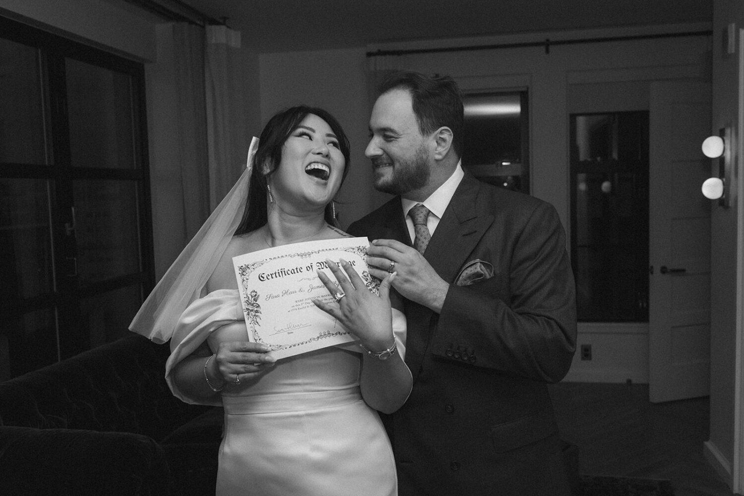 couple posing with their marriage certificate