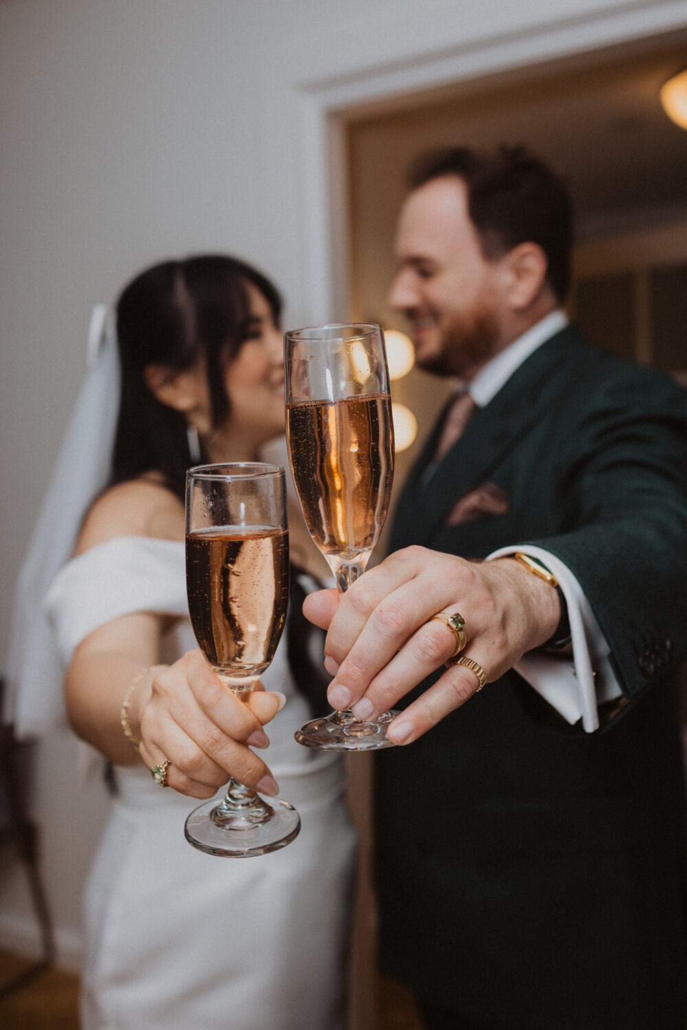 bride and groom cheers with champagne glasses