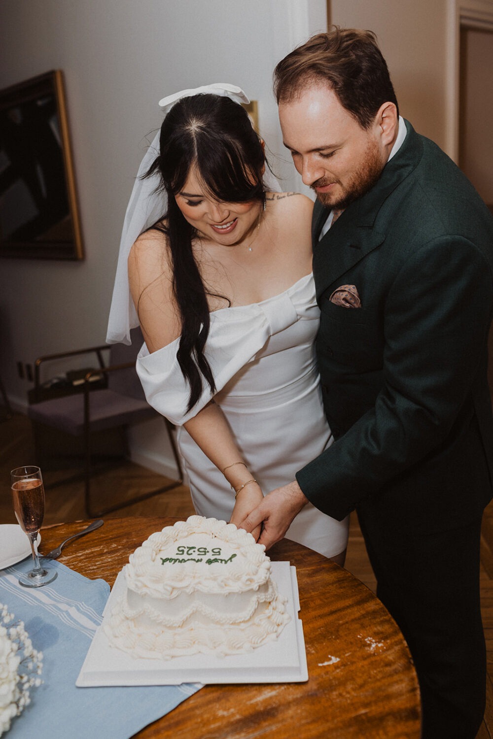 couple cutting wedding cake together