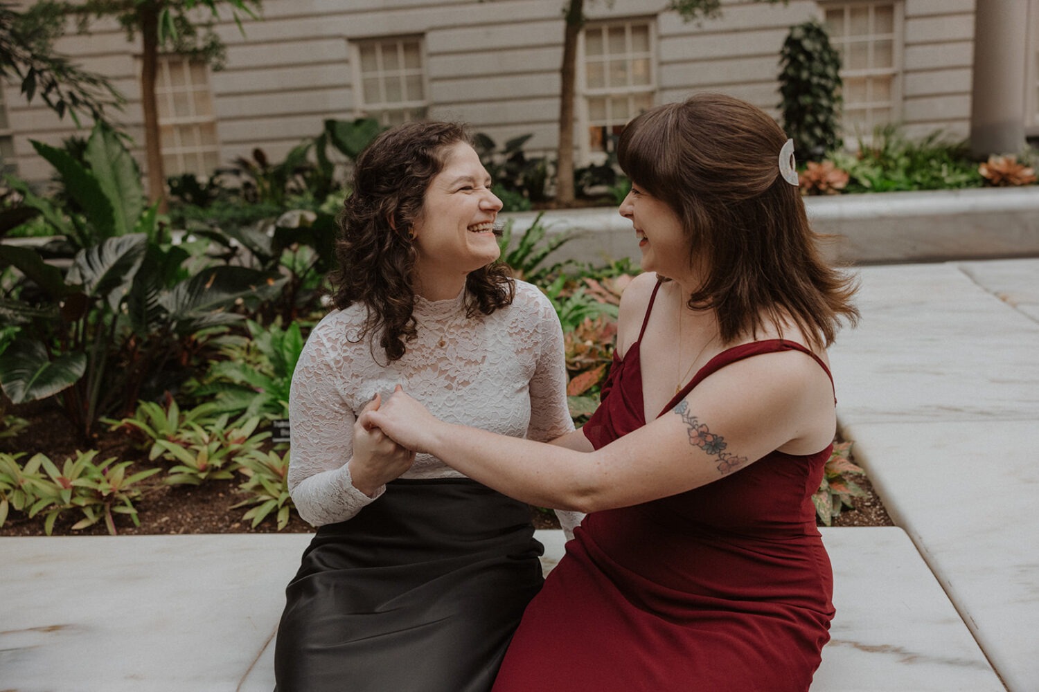 couple sit together in the garden area of the Portrait Gallery