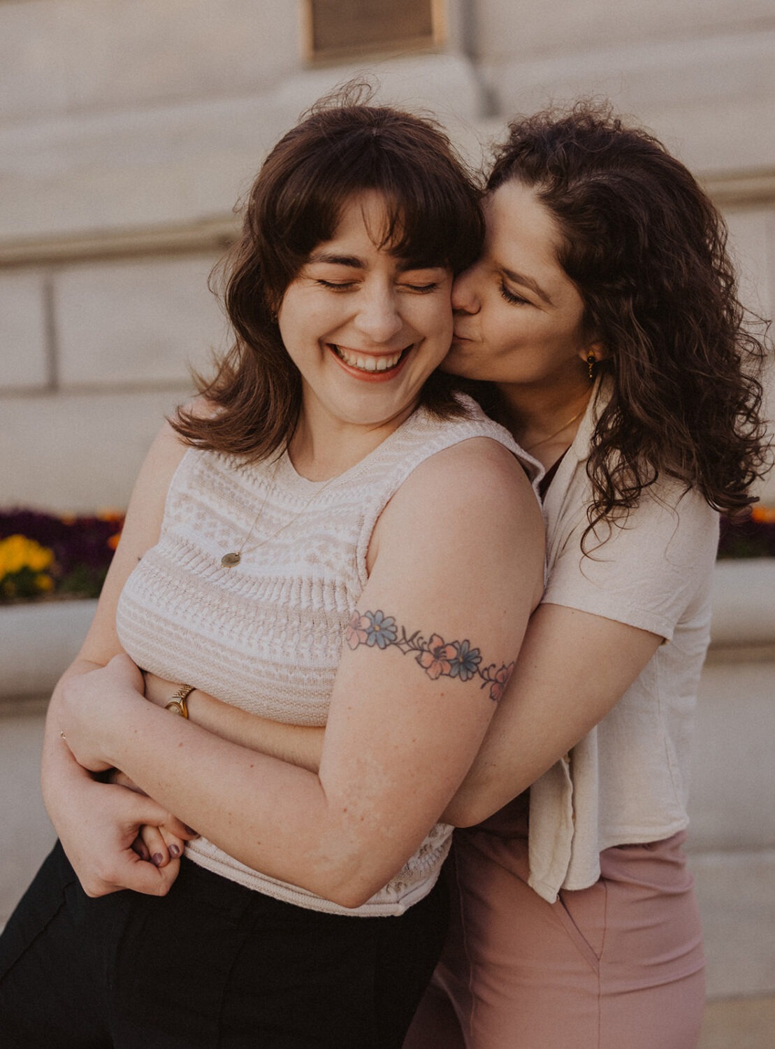couple embrace in front of Library of Congress