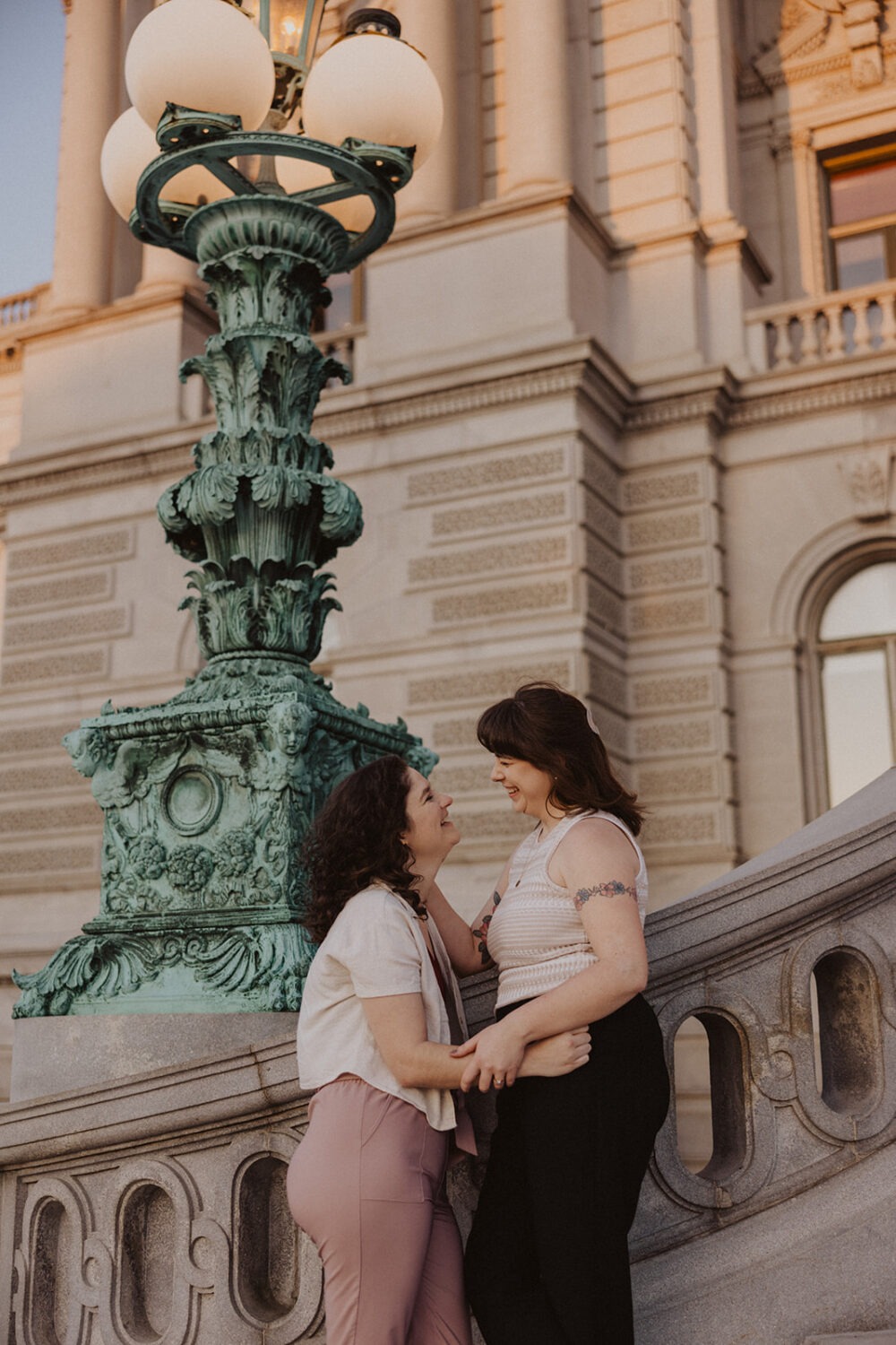 couple pose on steps of the Library of Congress