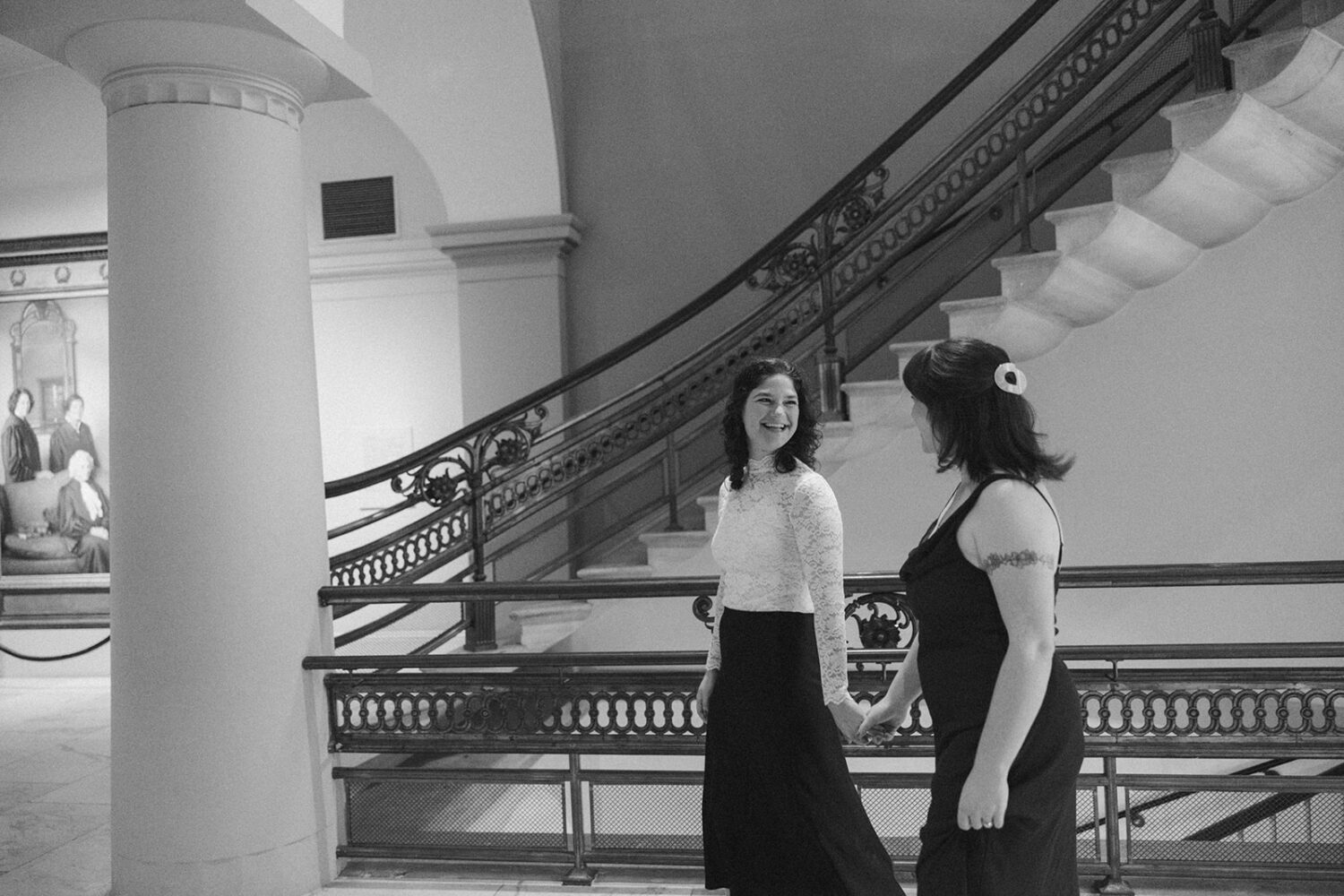 couple walk together holding hands during engagement photoshoot