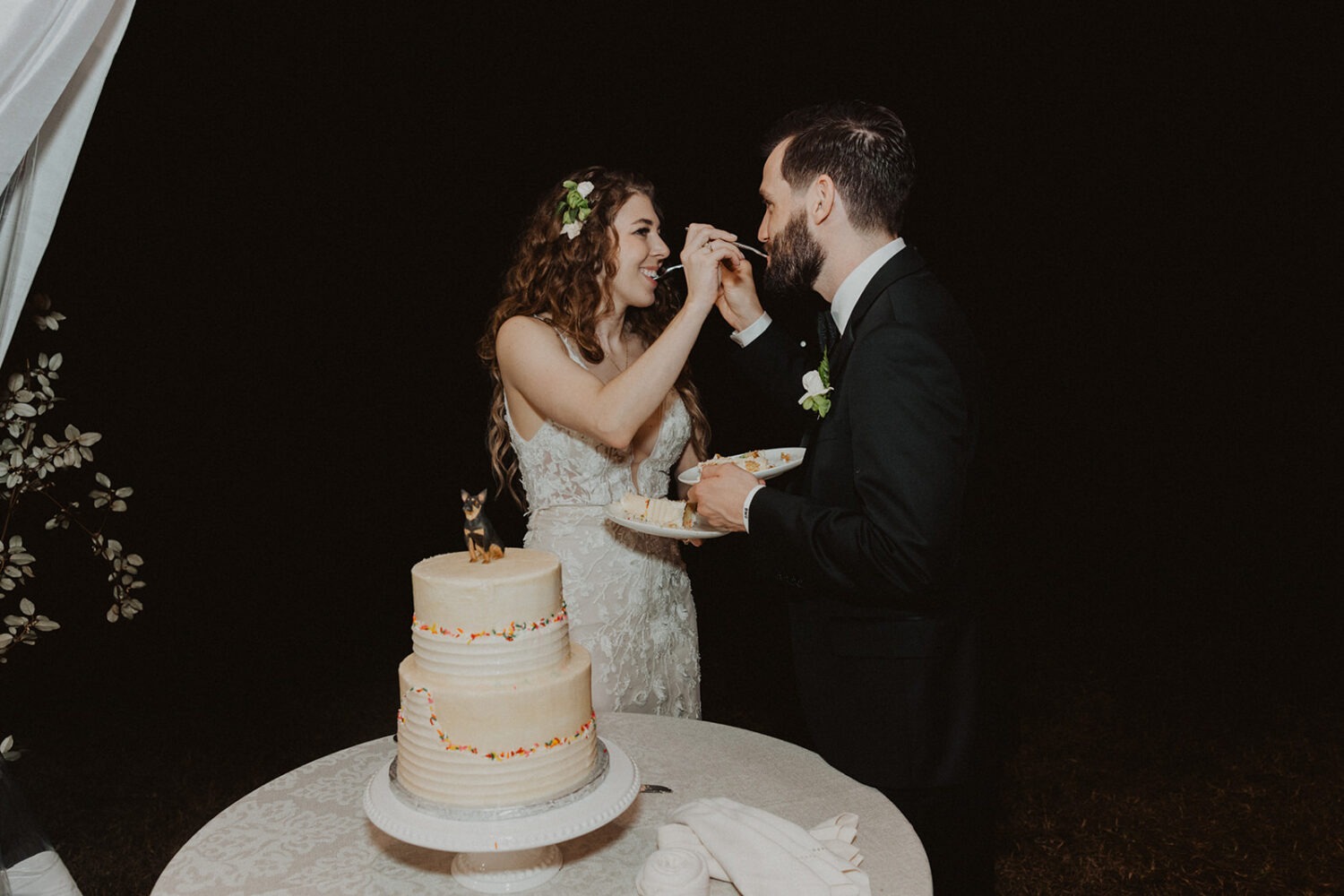 couple feed each other cake 