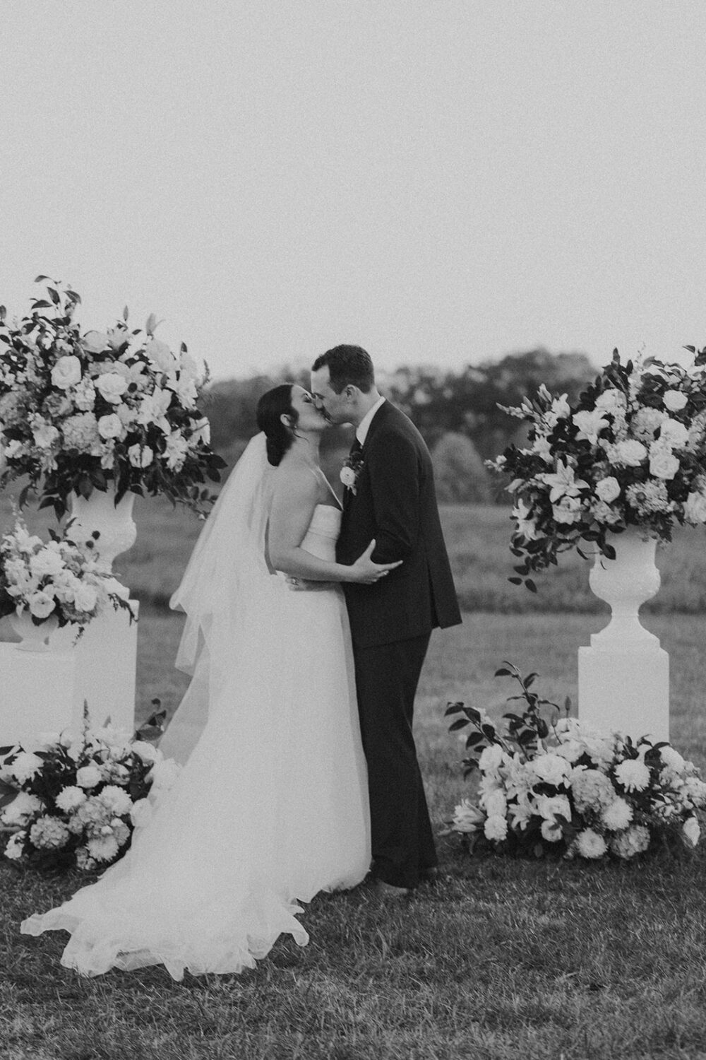 couple kiss during ceremony at National Arboretum wedding