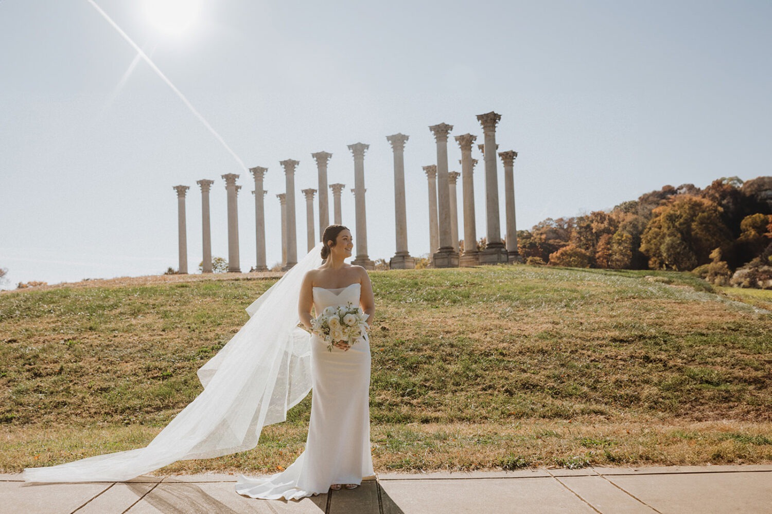 bride poses in front of National Capitol columns