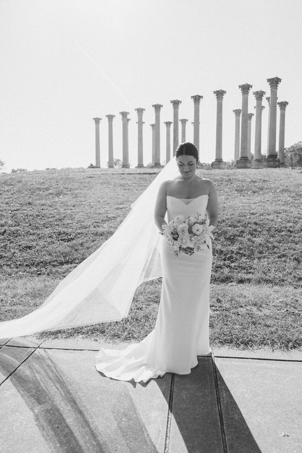 bride poses in front of National Capitol columns