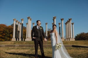 couple poses in front of National Capitol Columns