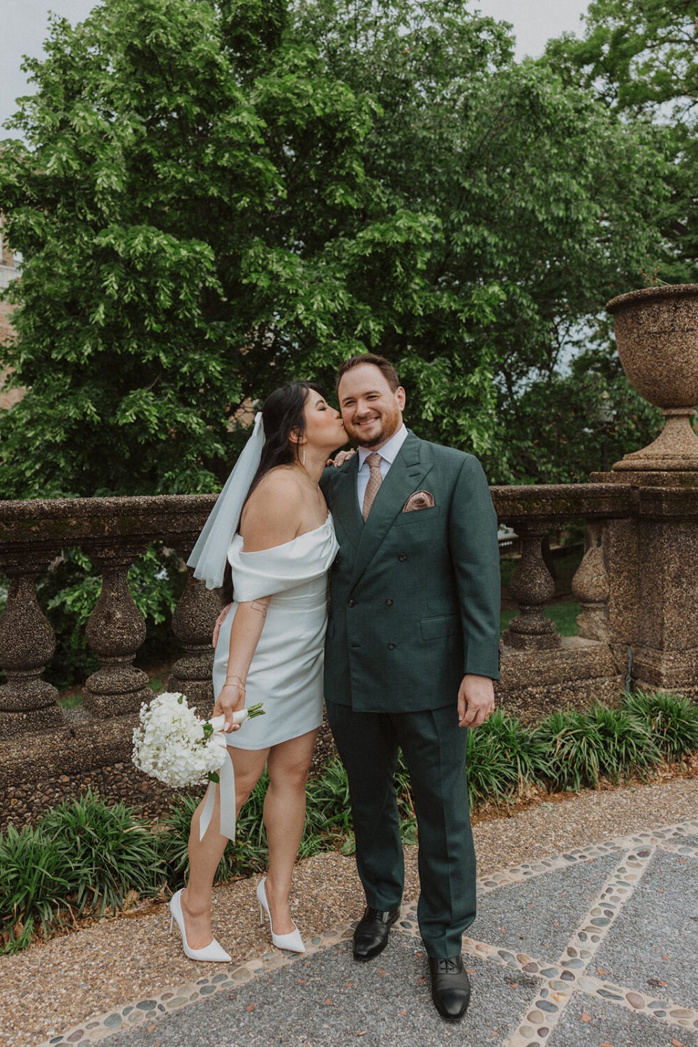 couple embrace and kiss in Meridian Hill Park