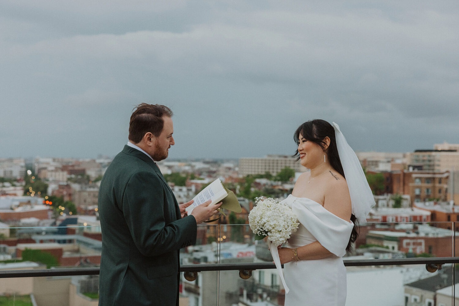 groom reads vows during rainy wedding day