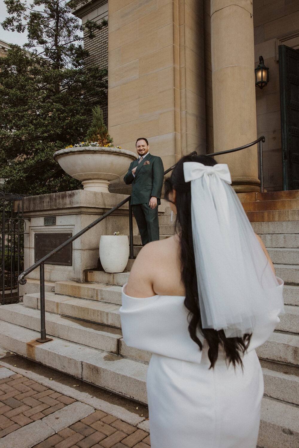 couple pose in front of steps 