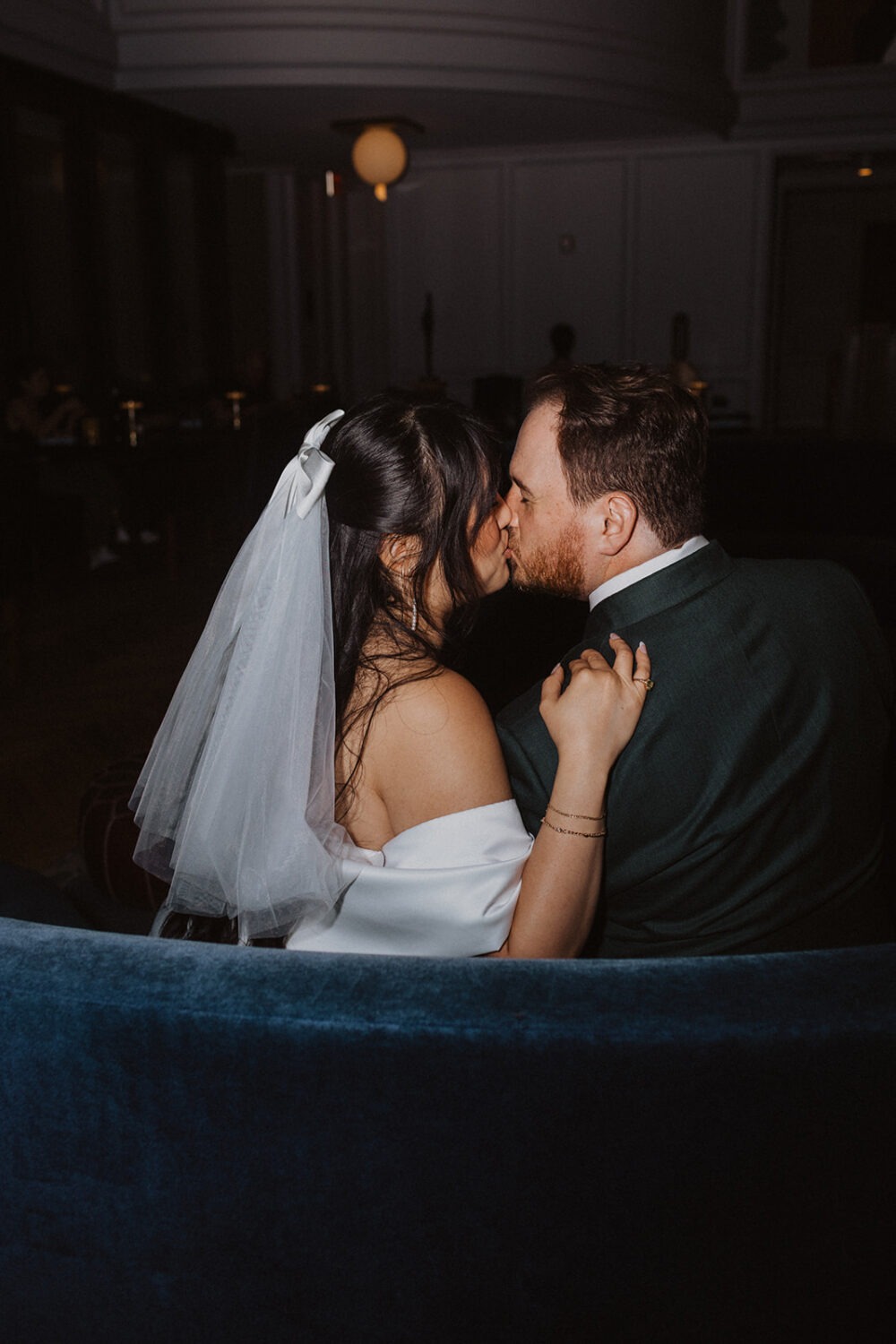 couple kiss on blue couches in the Line Hotel
