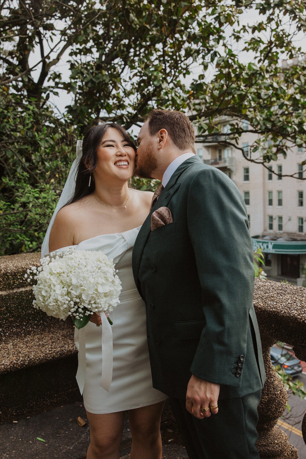 couple embrace and kiss in Meridian Hill Park