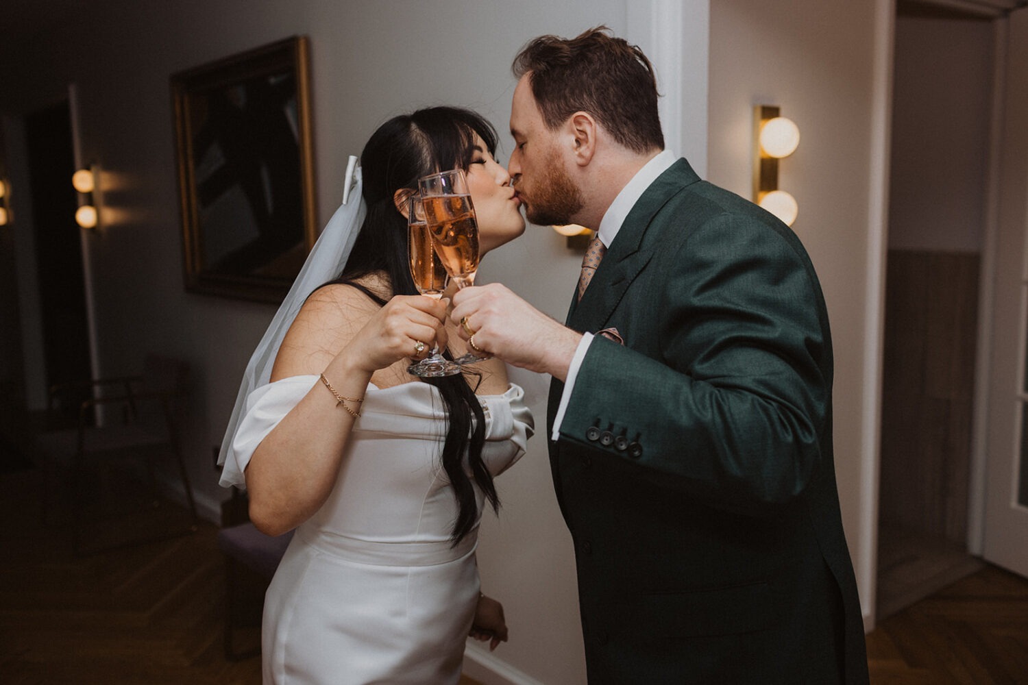 couple kiss while toasting with champage