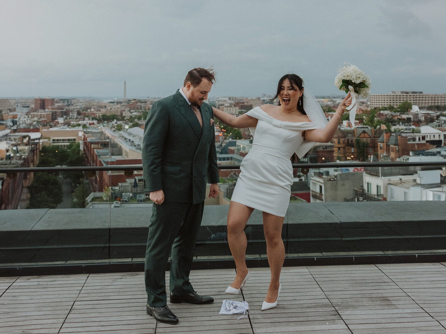 couple pose during ceremony on rainy wedding day