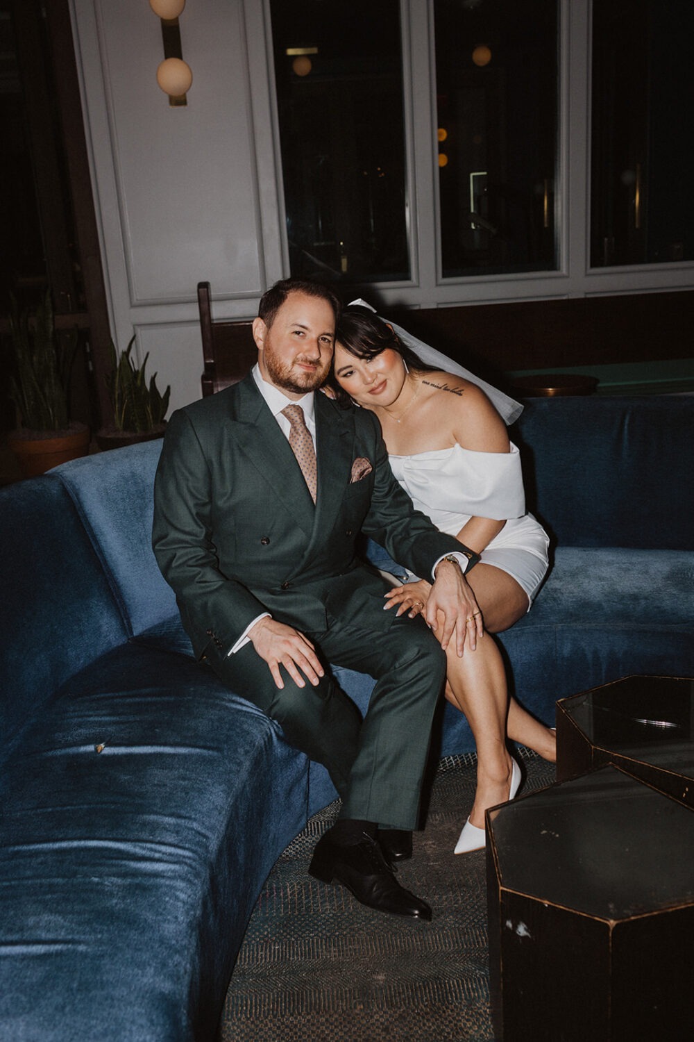 couple pose of blue couches in the Line Hotel