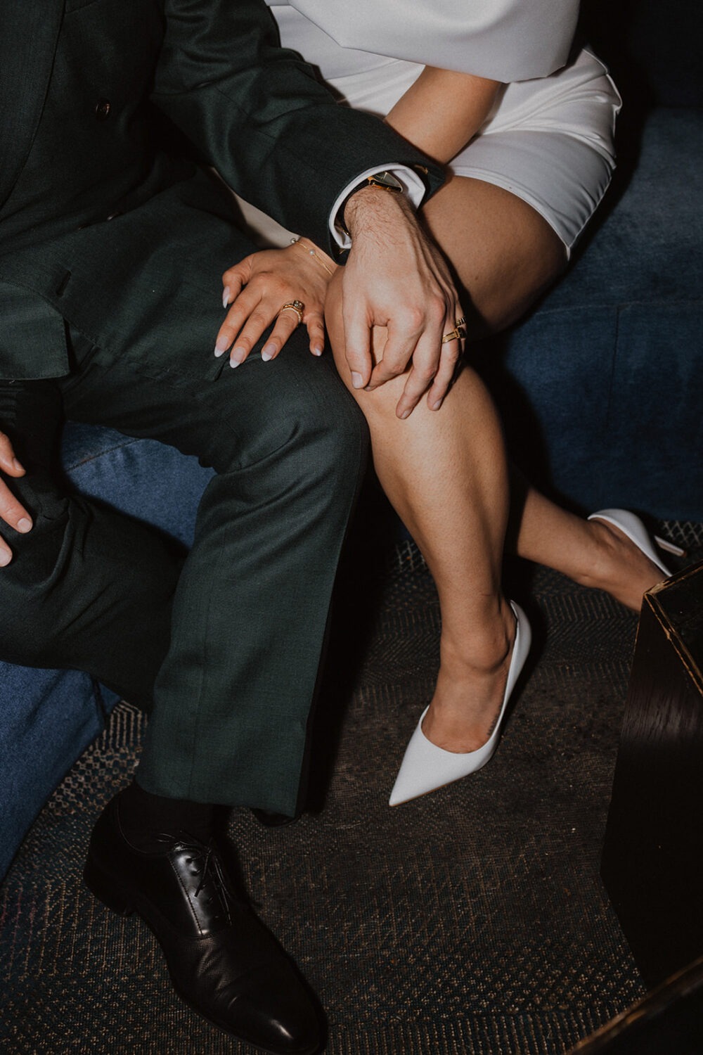 couple pose of blue couches in the Line Hotel