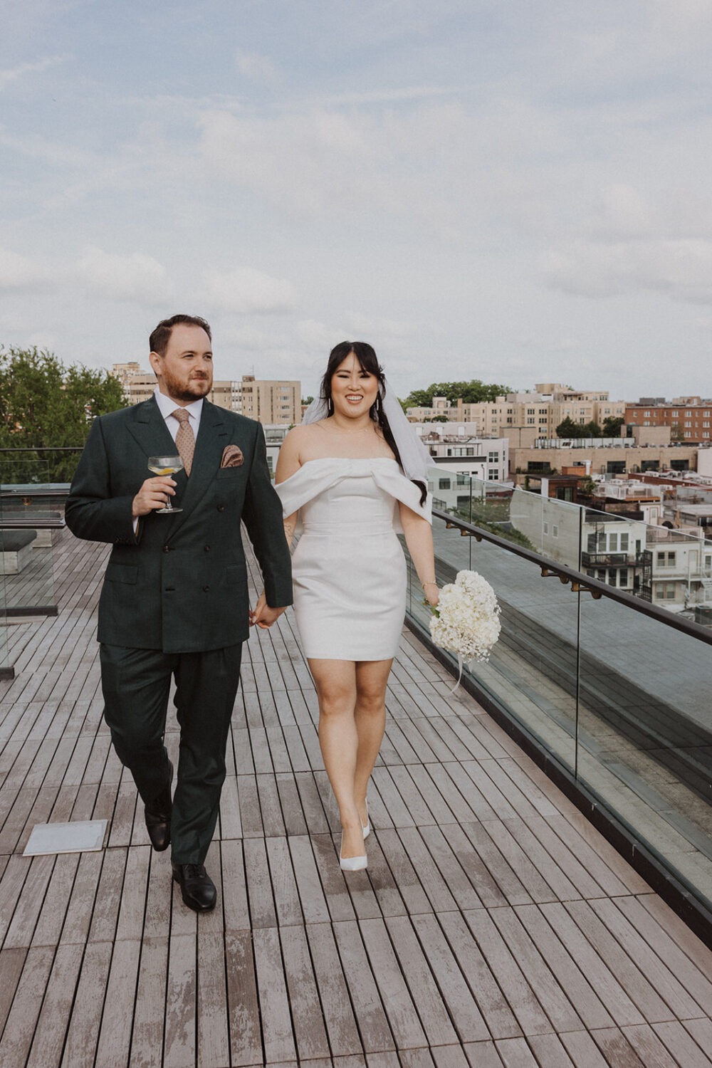 couple walking and holding hands on terrace of the Line Hotel