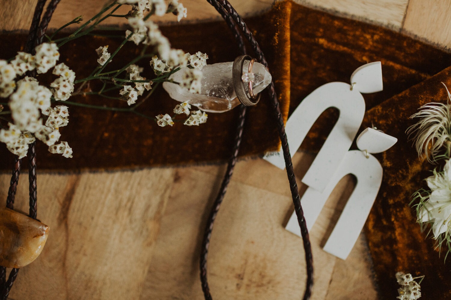 wedding flat lay with earrings and rings
