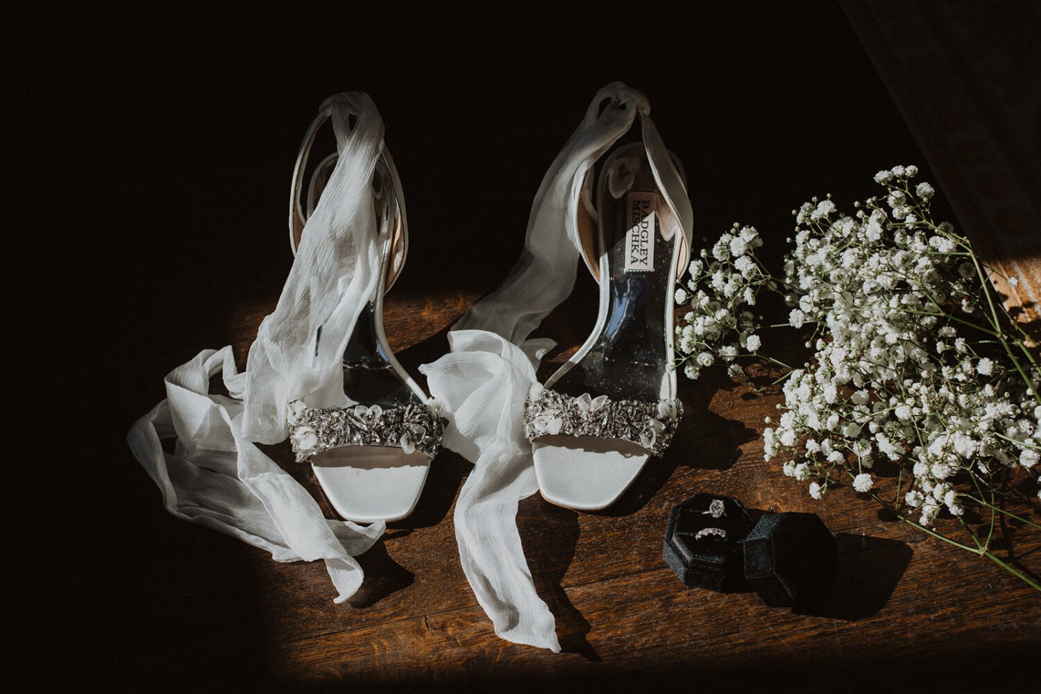 wedding flat lay details with shoes, jewelry, and florals