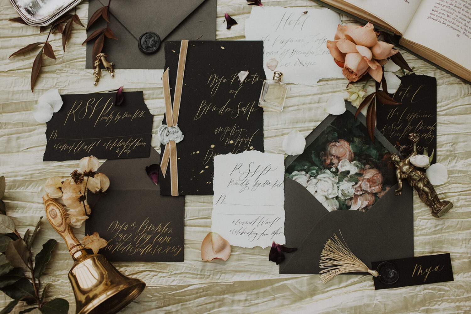 wedding flat lay details with invitation, jewelry, and florals