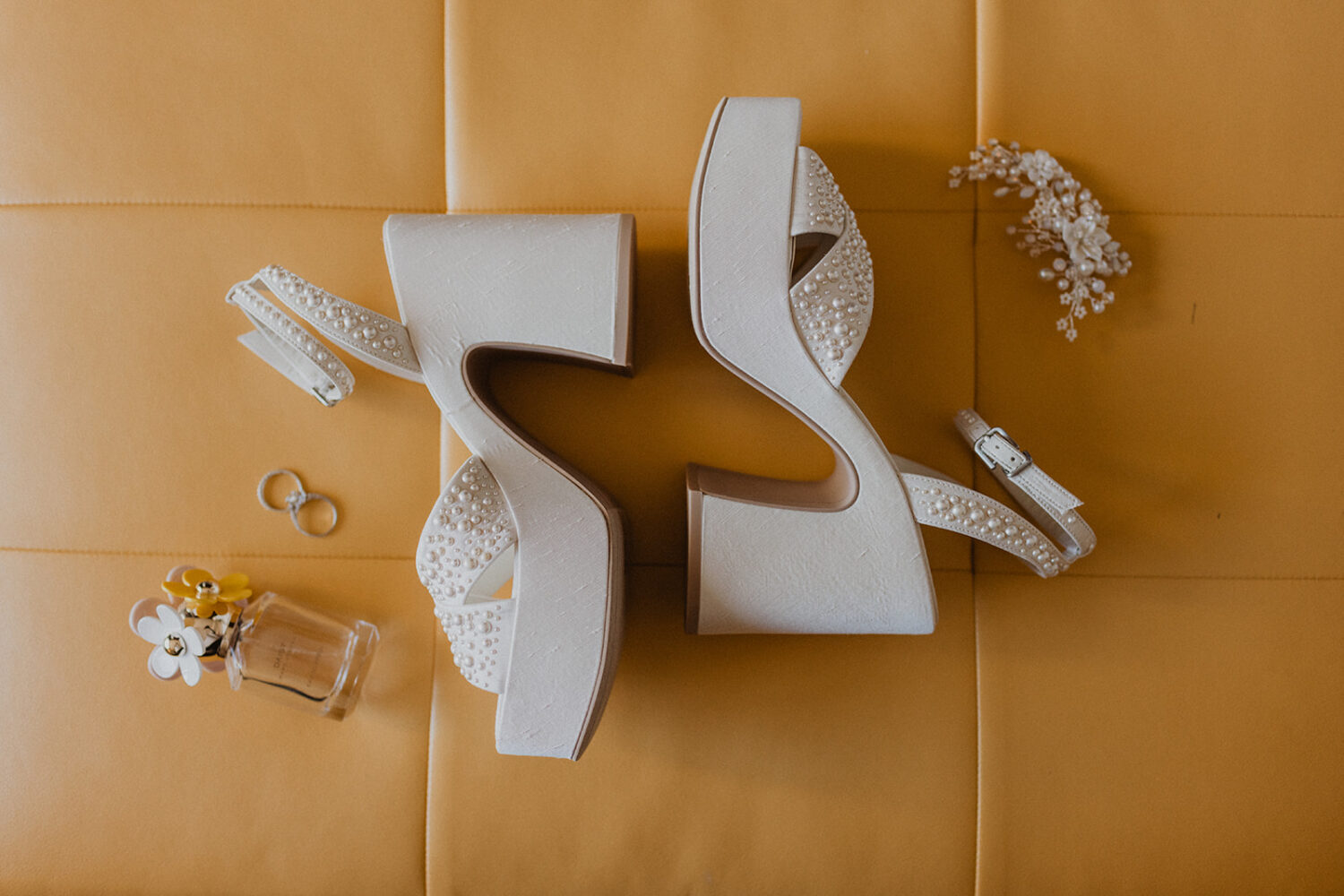 bridal details including shoes, perfume, and rings