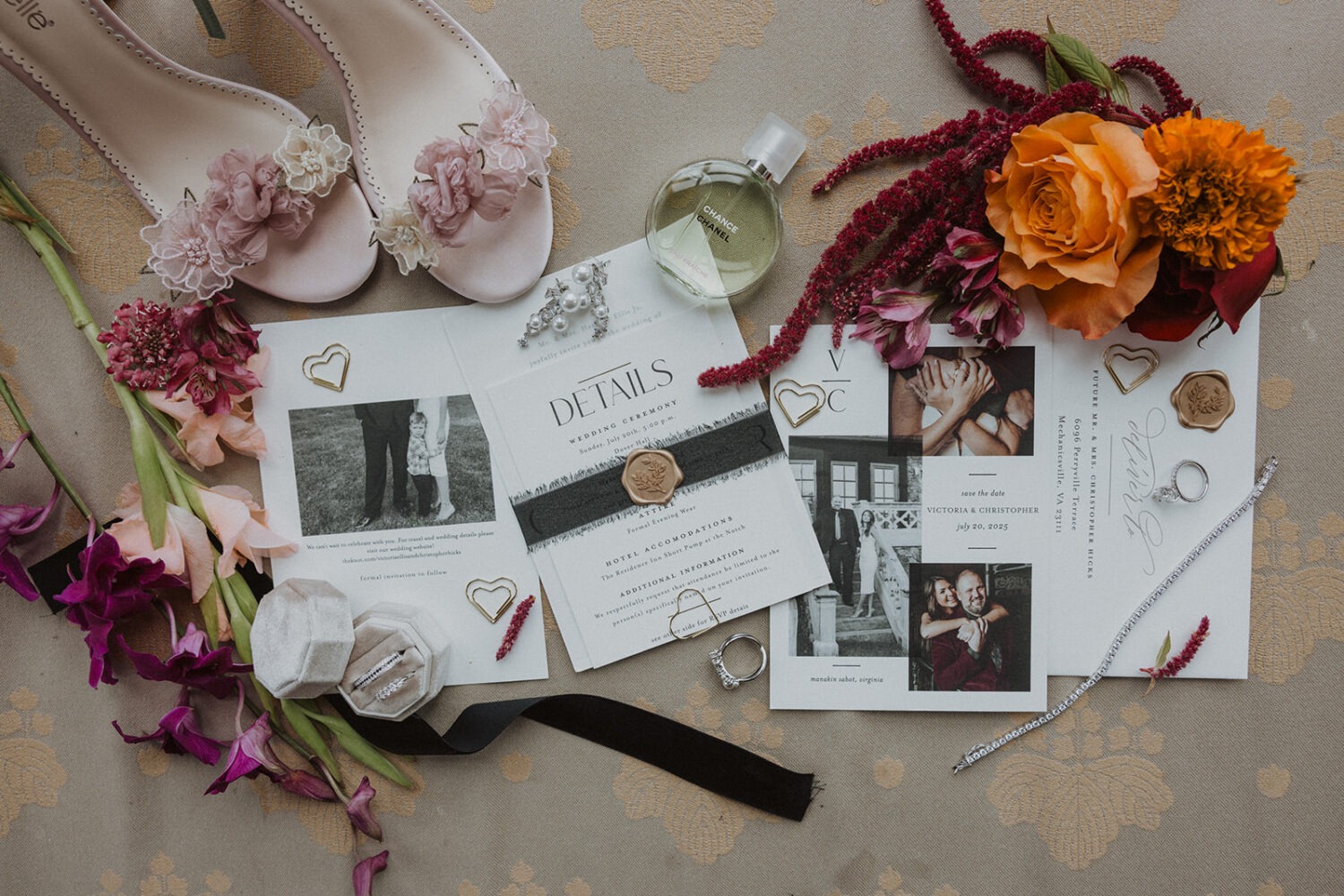 wedding flat lay details with invitation, jewelry, and florals