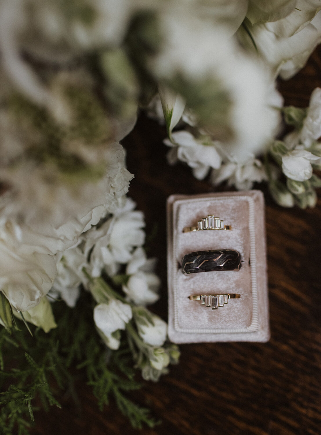 detail shot of wedding rings with florals