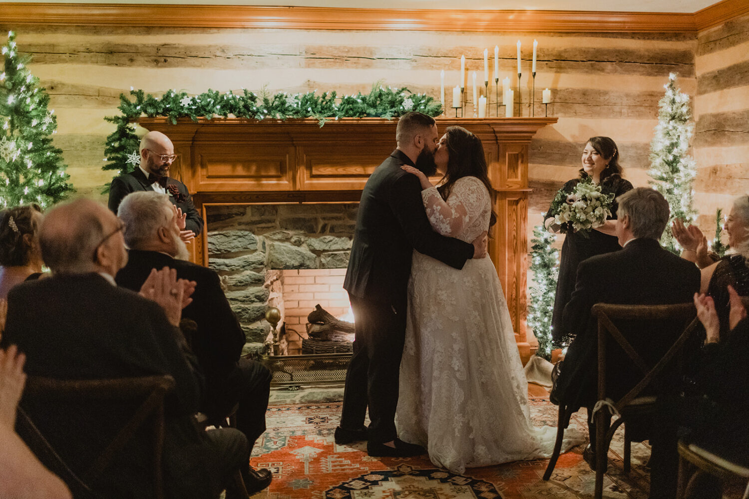 couple kiss during Christmas wedding ceremony