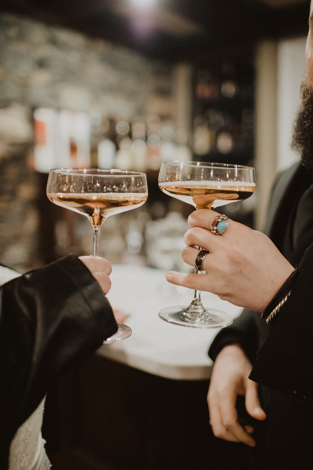 two people holding up martini glasses