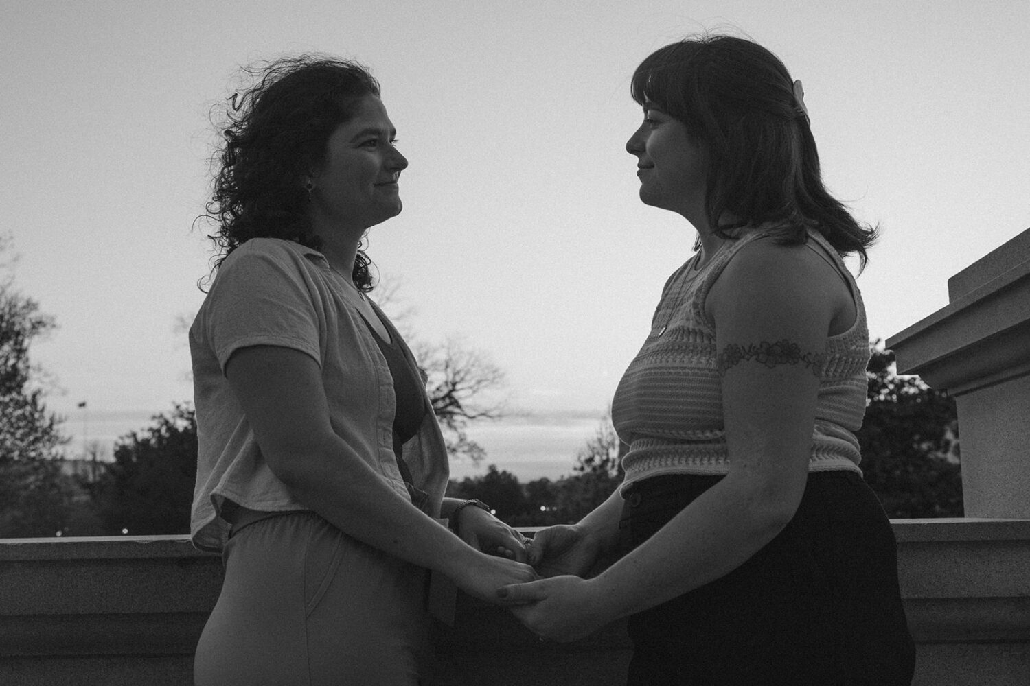 couple hold hands during sunset shoot