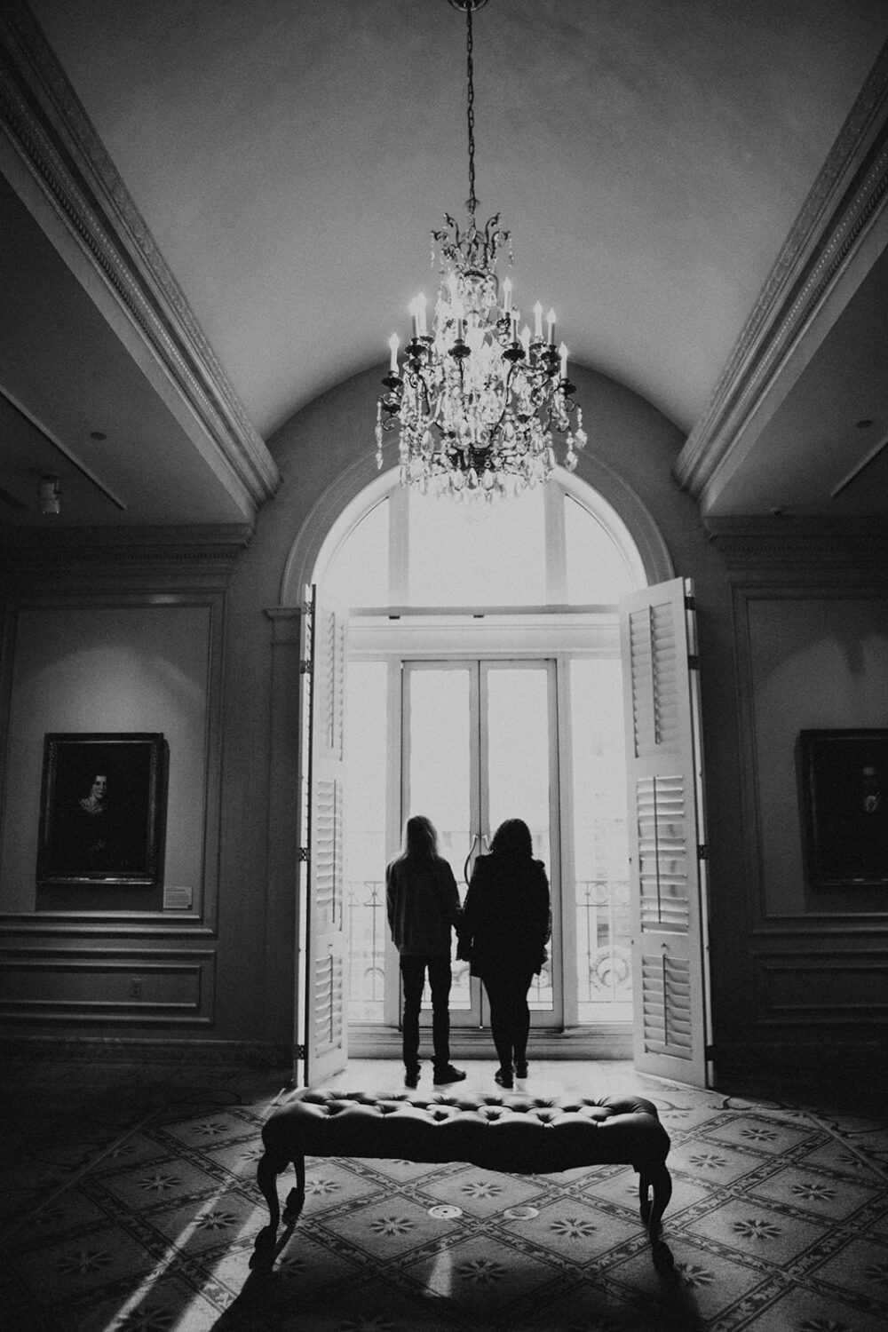 couples photoshoot ideas in front of large windows