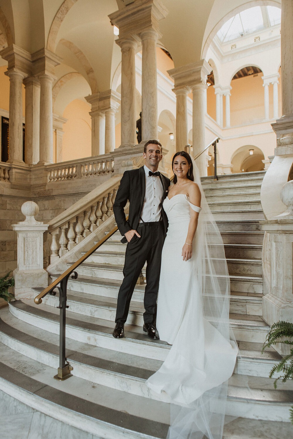 couple poses on the steps of the Walters Art Museum