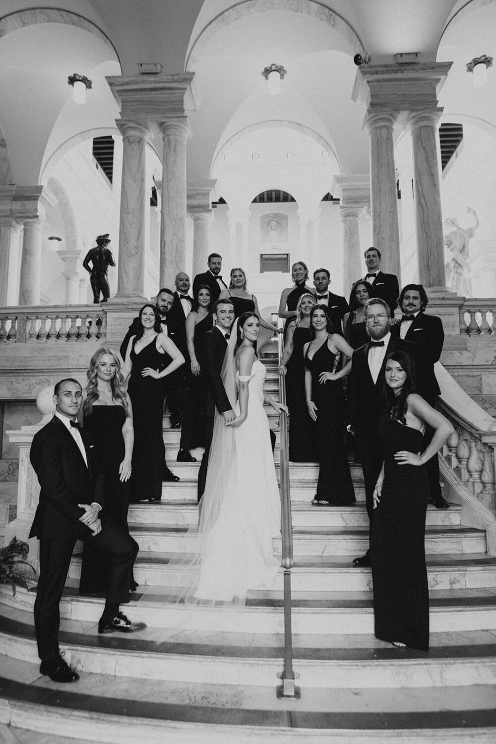 couple and wedding party pose on steps